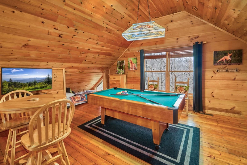 The large loft has a Pac-man arcade game, ROKU TV, and pool table.
