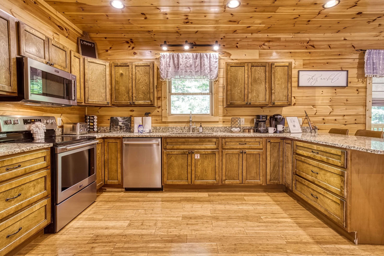 Woodness Gracious fully furnished kitchen with stainless steel appliances