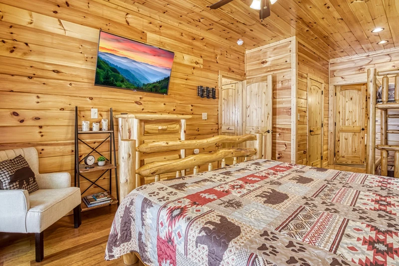 Woodness Gracious main level bedroom with king size bed and 50 inch TV