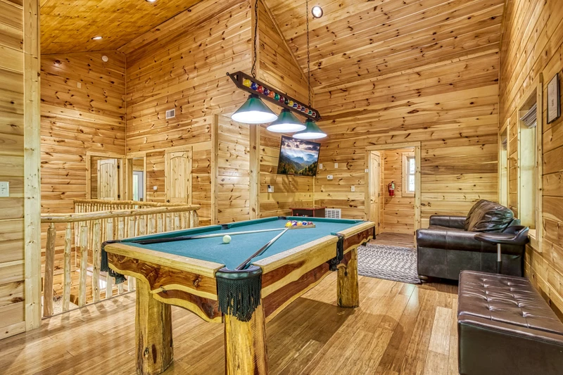 Woodness Gracious upper level game room with pool table and cocktail style multi-cade arcade game