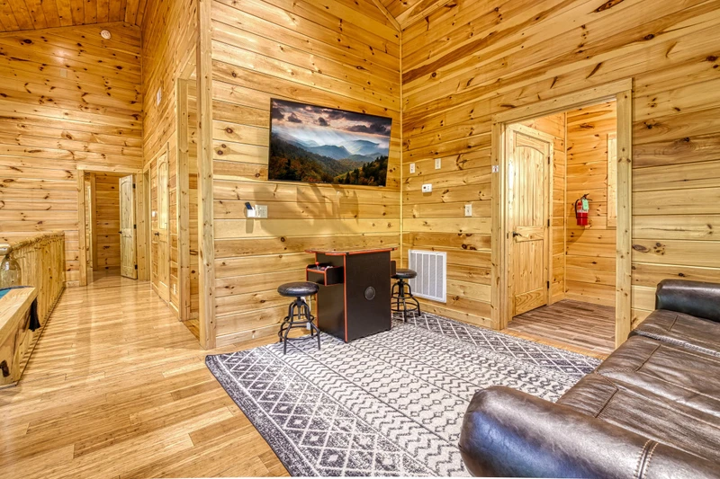 Woodness Gracious upper level game room with cocktail style multi-cade arcade system