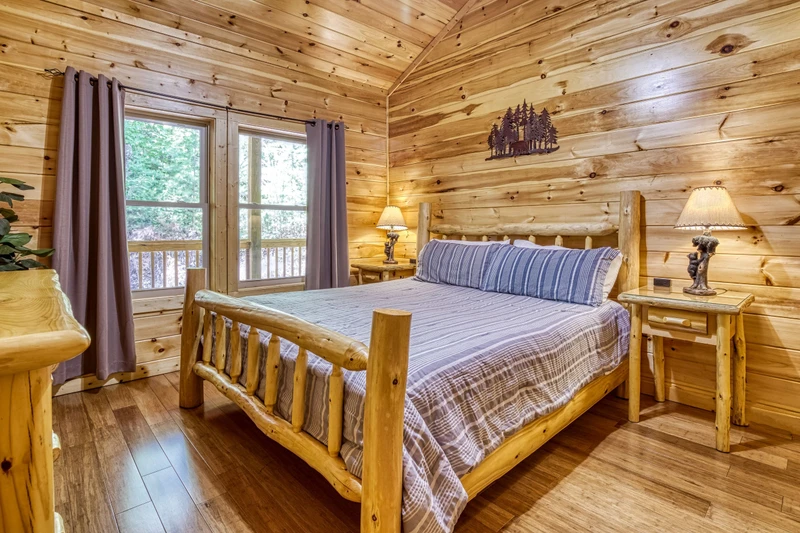 Woodness Gracious upper level bedroom with king size bed and deck access