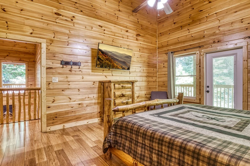 Woodness Gracious upper level bedroom with 50 inch TV and king size bed