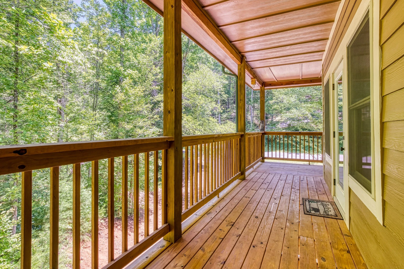 Woodness Gracious upper level covered wrap around deck