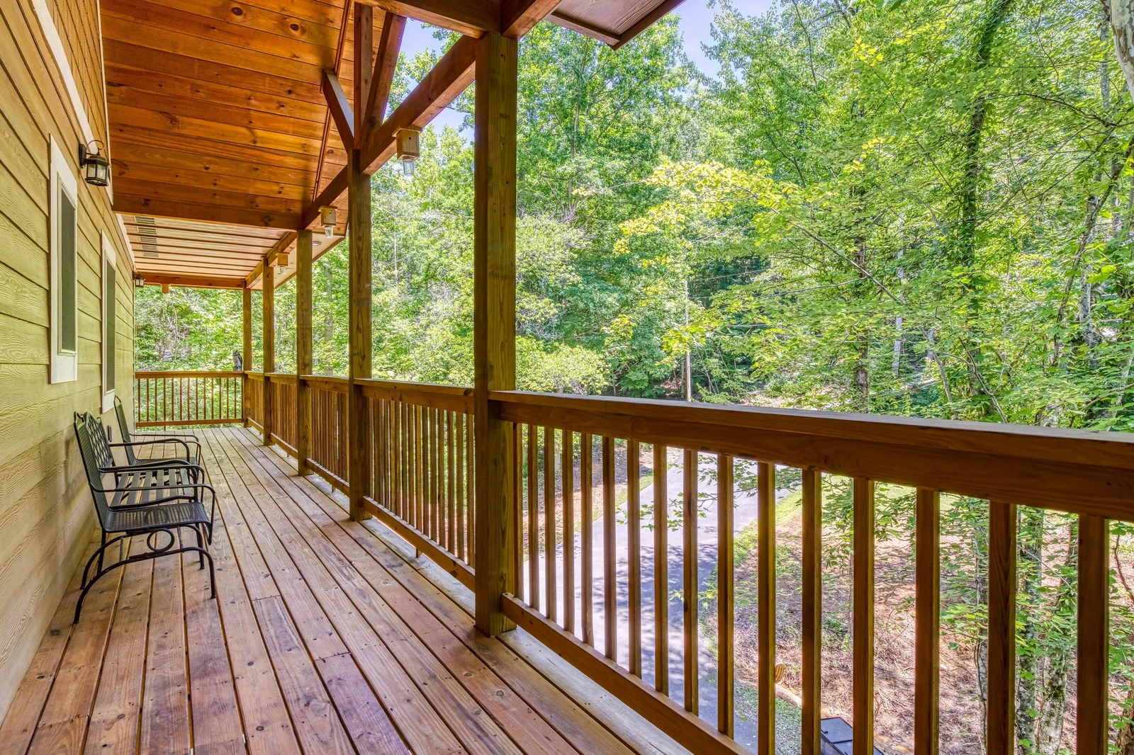 Woodness Gracious covered wrap around deck located on the upper level 