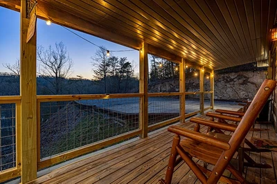 Smokies cabin with lighted covered porch.