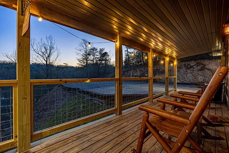 Smokies cabin with lighted covered porch.