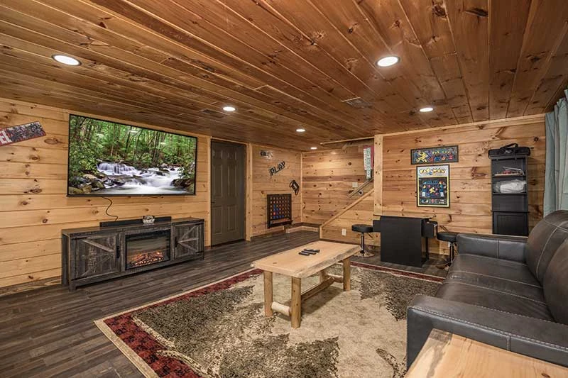 A big screen tv in the cabin game room.