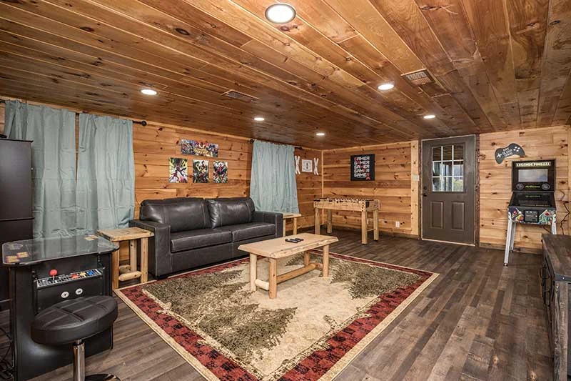 Roomy cabin game room with fireplace and big tv.