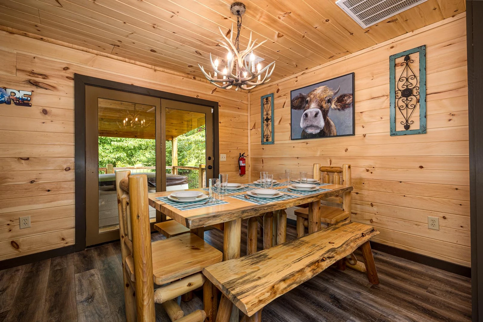 Cabin dining room with log table and bench.