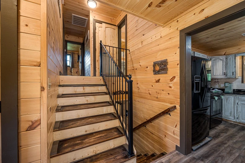 Cabin stairway upstairs and down to the game room.