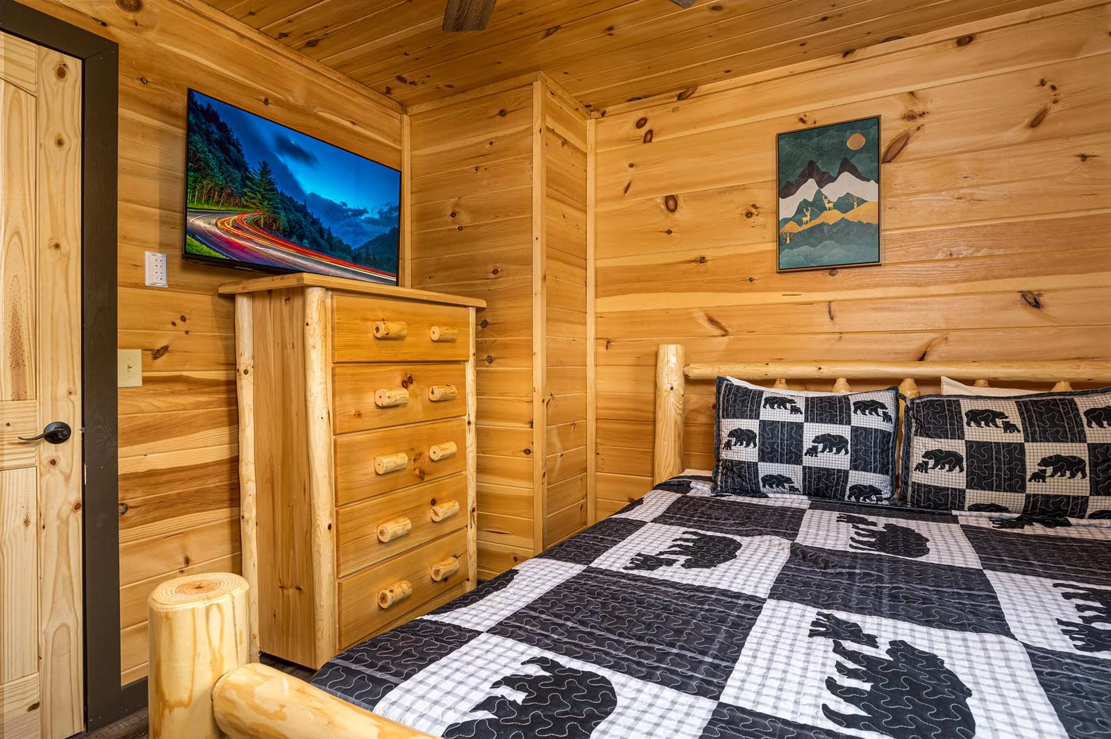 Rental cabin bedroom with tv.