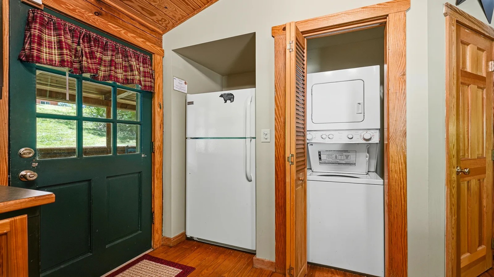 Cabin rental's stacked washer-dryer and full sized fridge.