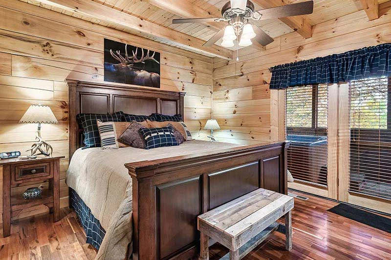 Rental cabin's large bedroom with walk out to the hot tub. 