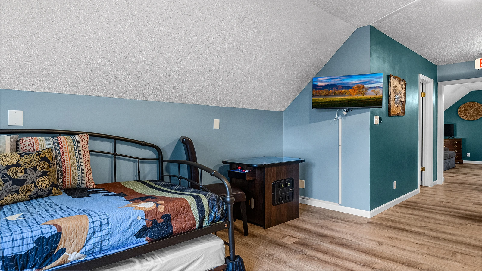 The game room offers more sleeping space with a flat screen TV. 