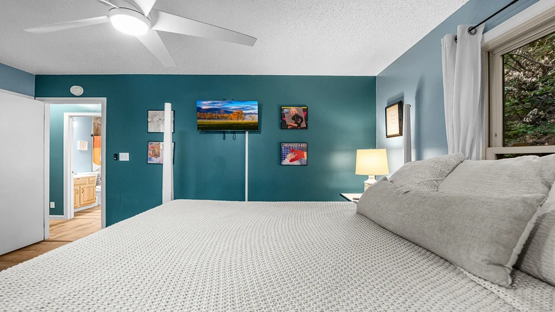 Chalet second bedroom offers a king size four post bed along with flatscreen tv for late nights.