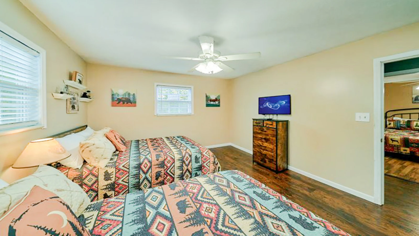 Third bedroom with two full beds and television.