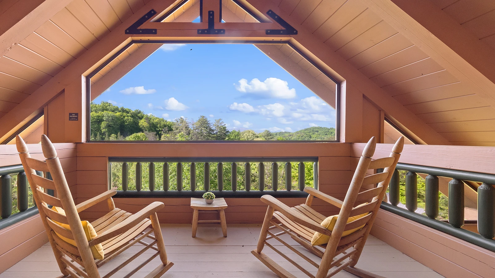 Smoky Mountains enclosed cabin porch with rockers.