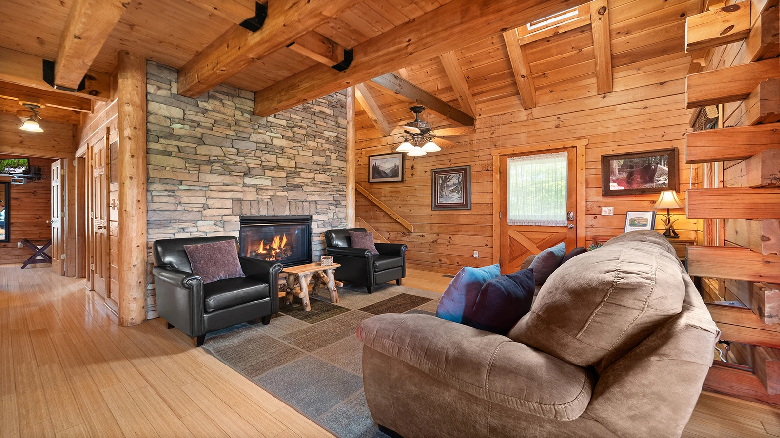Seasonal warmth comes from the cabin's stacked stone fireplace.