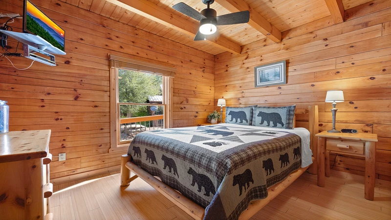 Third bedroom with large comfortable log bed and flat screen tv.