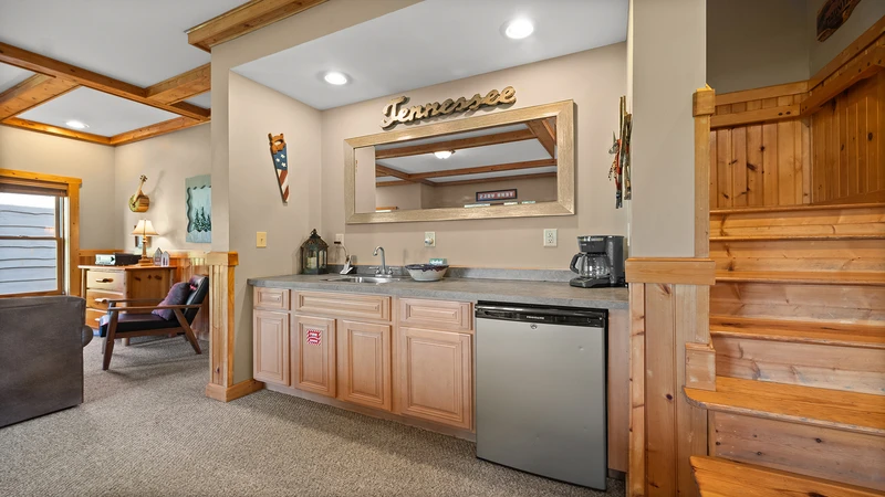 Convenient fridge and sink in your cabin's game room.