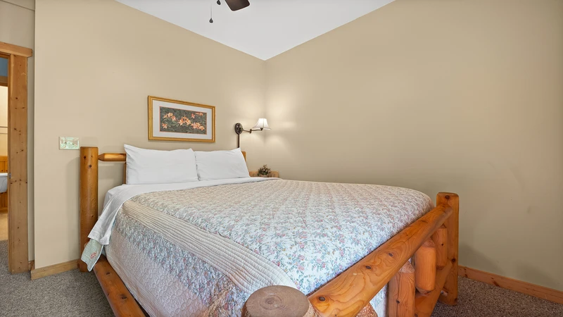 Relaxing log bed in the first of your cabin's 4 bedrooms.