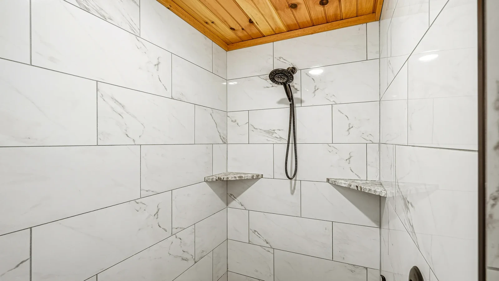 Beautiful cabin shower with shelving at your cabin in the Smokies.