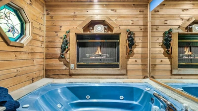 What a wonderful cabin setting, a Jacuzzi tub lit by the glow of the fireplace.