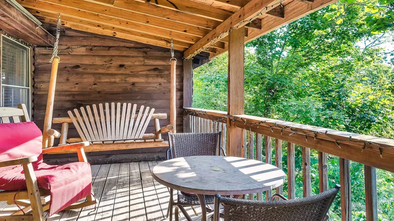 Relaxing porch swing, double rocker and card table all for enjoying moments surrounded by nature. 