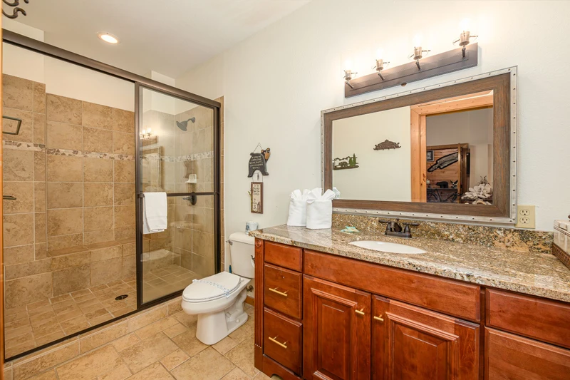 Bath with large tiled and glass shower.