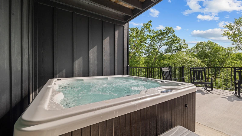 Hot tub on the very large deck of your Smoky Mountains cabin rental.