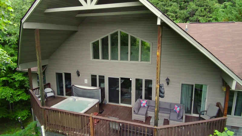 Large cabin deck with lots of seaing and family sized hot tub.
