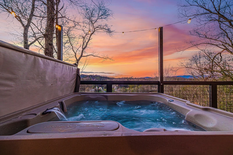 Relaxing hot tub with mountain views at your Smoky Mountain cabin rental. 