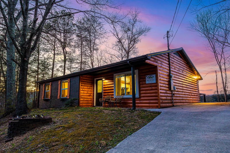 Smokies cabin exterior as the sun sets over the Smokies.