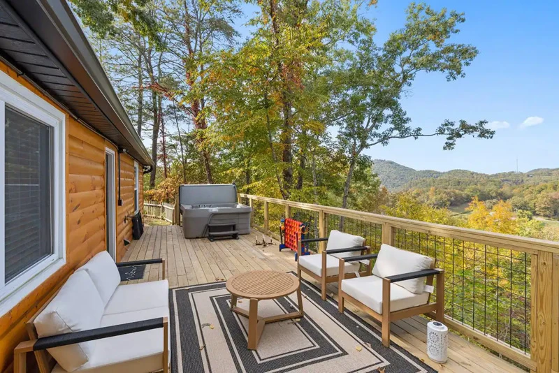 Smoky Mountains rental cabin deck with plenty of seating and mountain views.