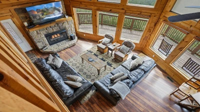 Looking down from the loft into the spacious living area with stone fireplace.