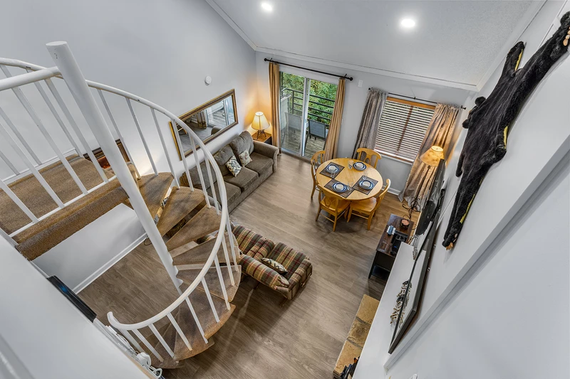 Cinderella staircase overlooking the living room of your condo.