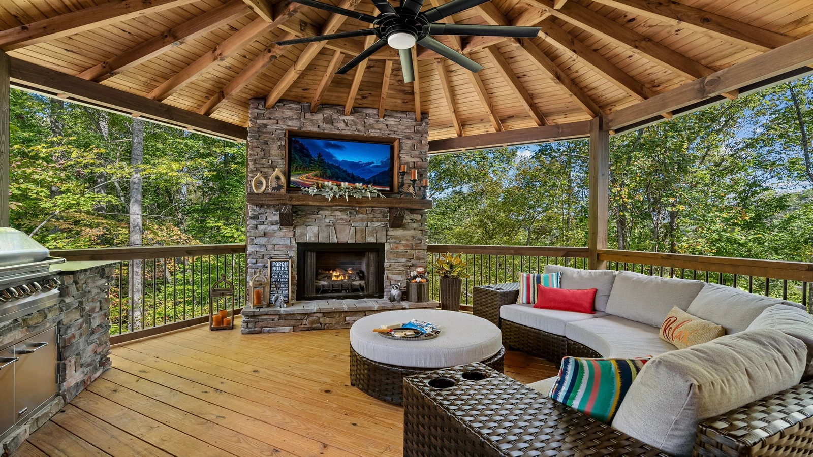 A custom outdoor kitchen, stacked stone fireplace, large flat screen TV and plenty of seating for family fun outdoors.