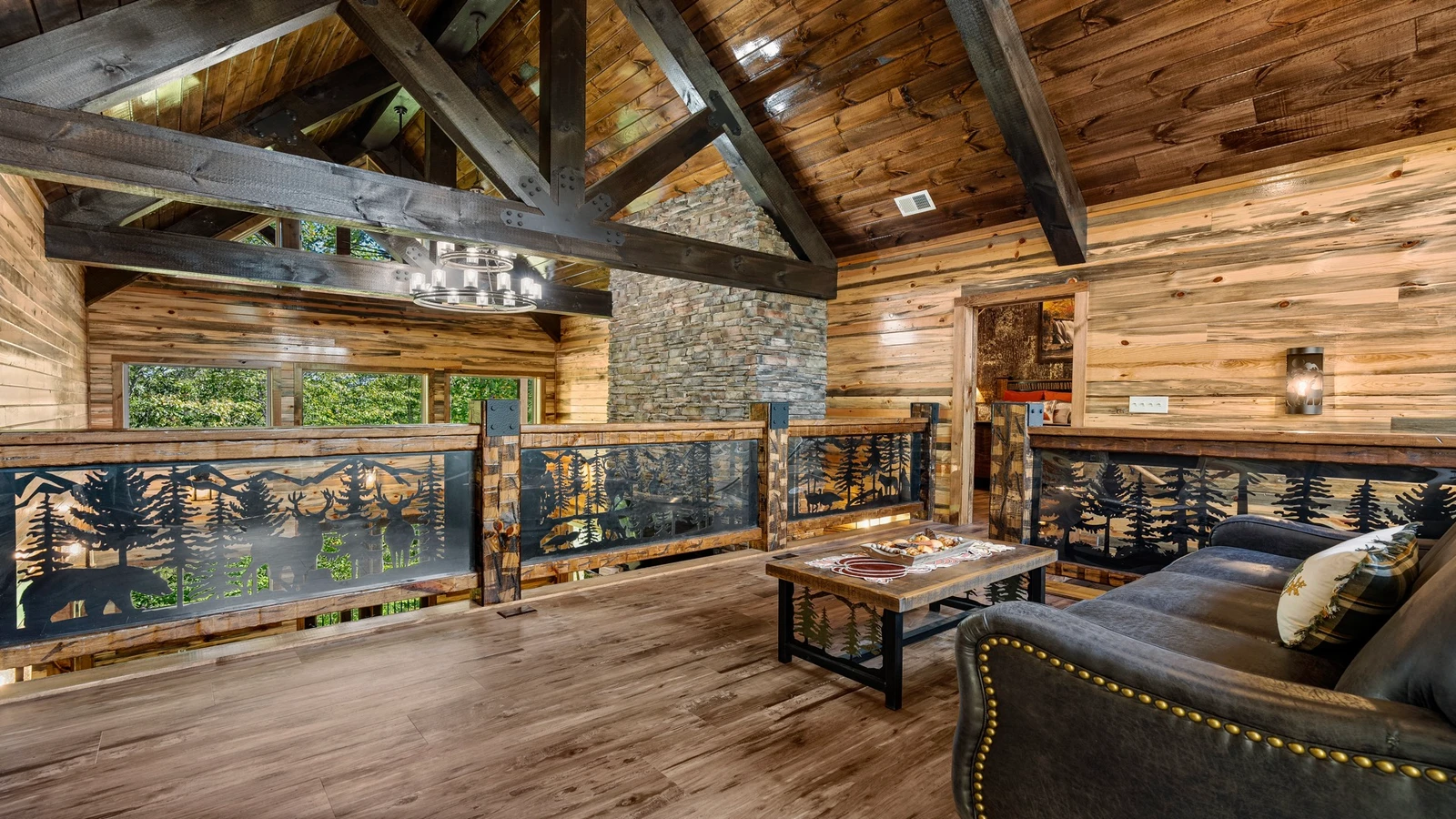 Your cabin's loft seating overlooks the large fireplace and living room below.
