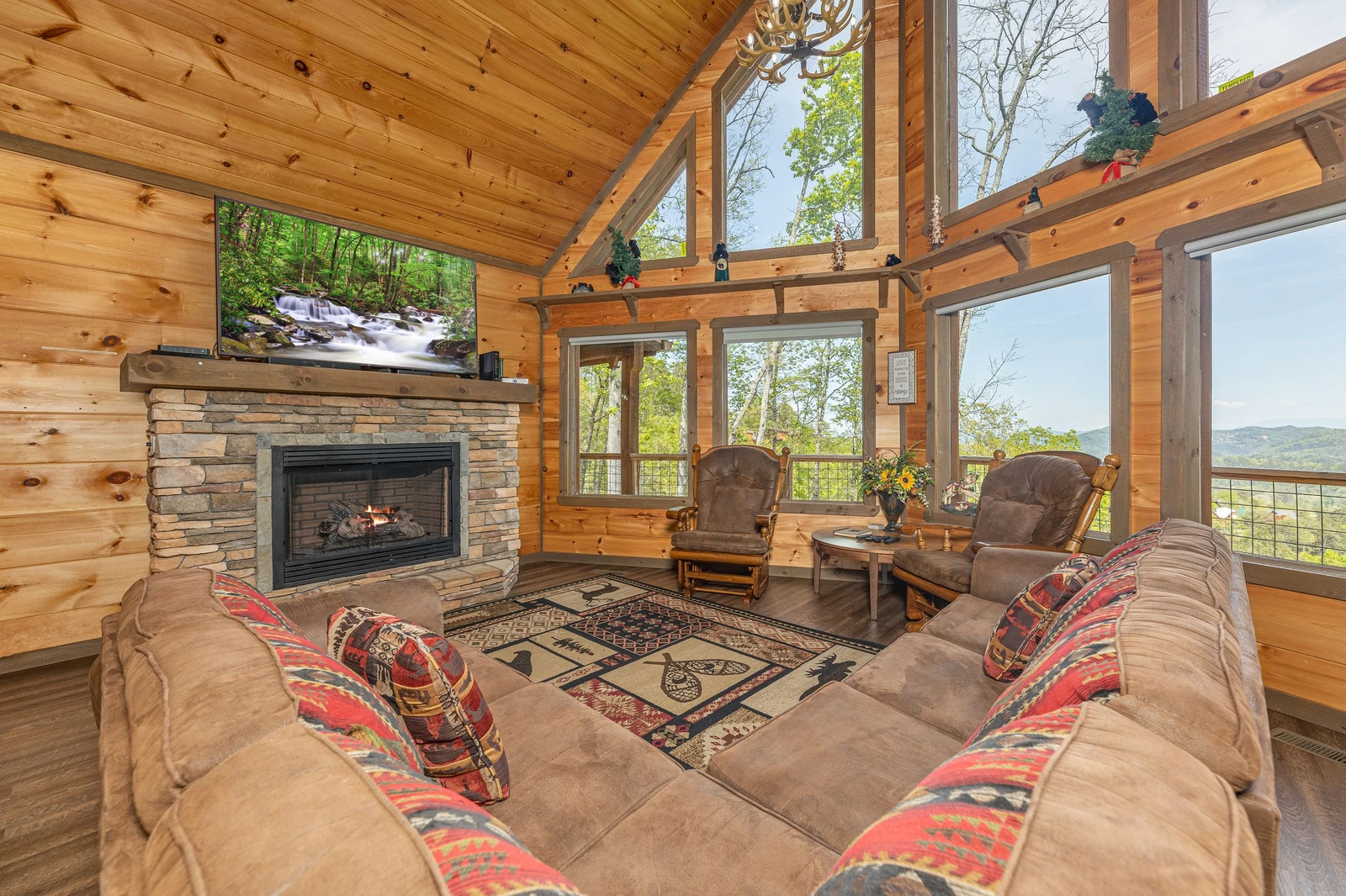 The Appalachian, a Pigeon Forge rental cabin with fireplace and large wall of windows.