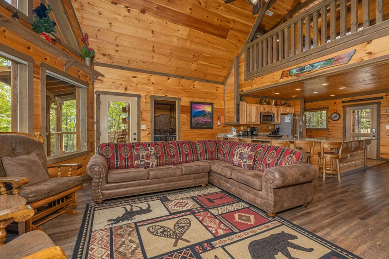 Cabin's living room seating towards the open kitchen.