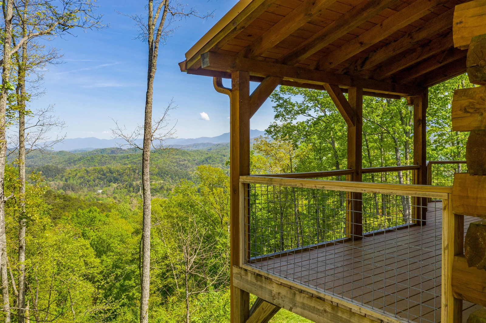 Take in spectacular views of the Smoky Mountains from your cabin's covered porch.