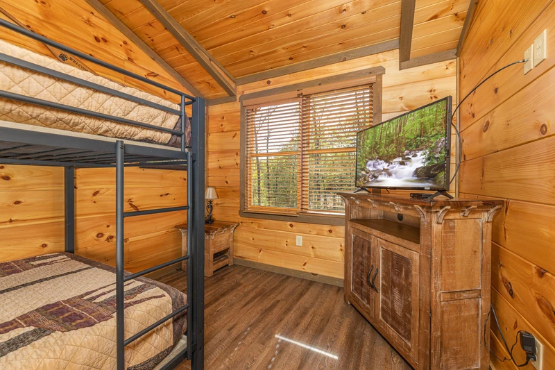 Bunk bedroom with television.
