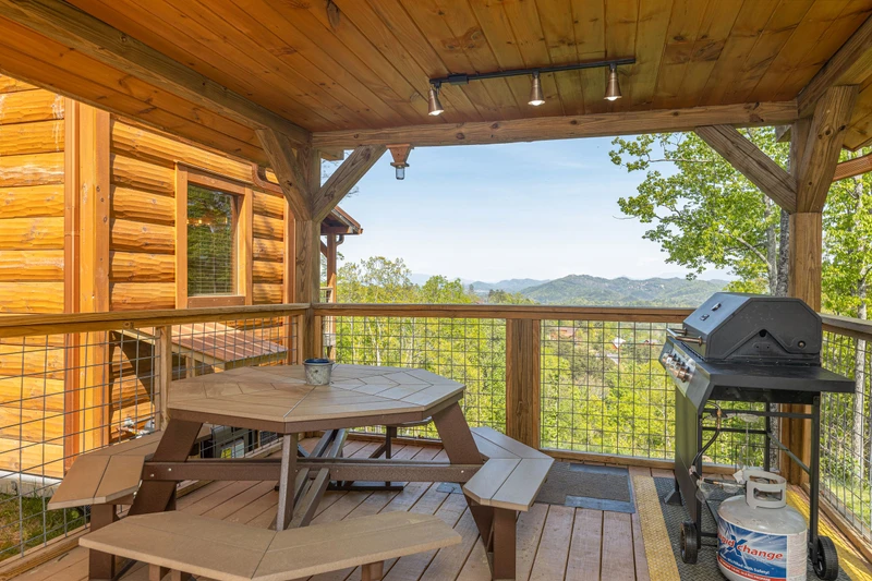 Pigeon Forge area cabin with picnic table and gas grill on the porch.