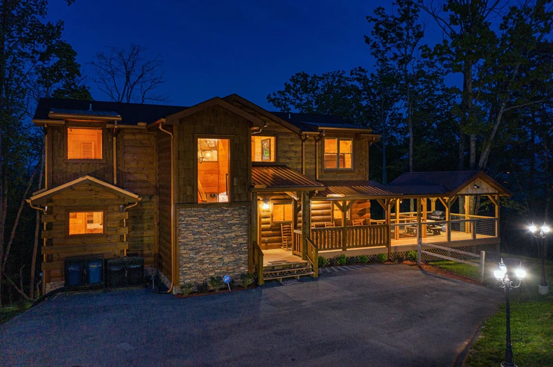 Dusk settles over your large Pigeon Forge cabin in the Tennessee Smoky Mountains. 