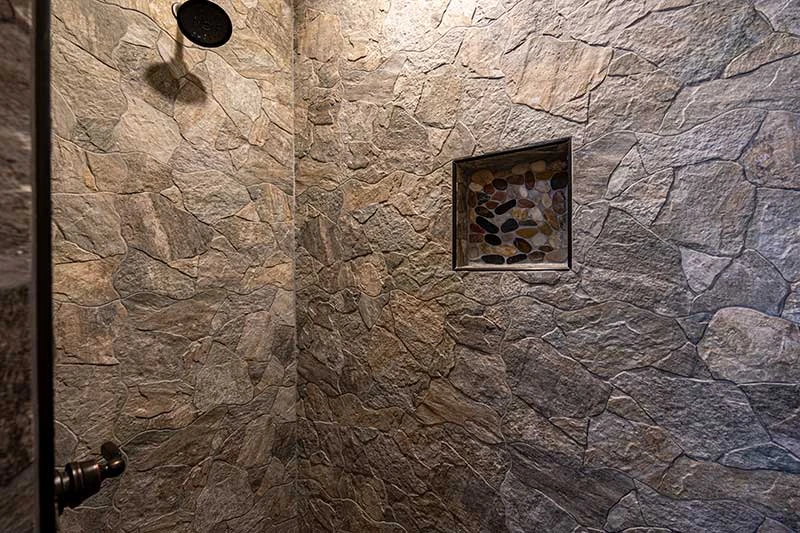 Stone covered shower in your 3rd bedroom.