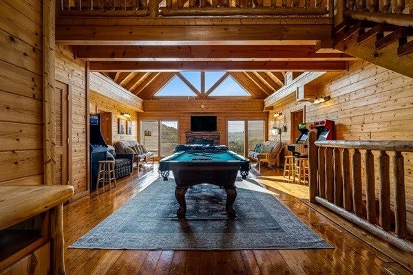 Spacious Game room with our full-size pool table, large TV, comfortable seating, arcade machines, and magnificent mountain views