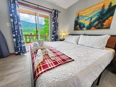 King size bed overlooking the mountains by the main living area