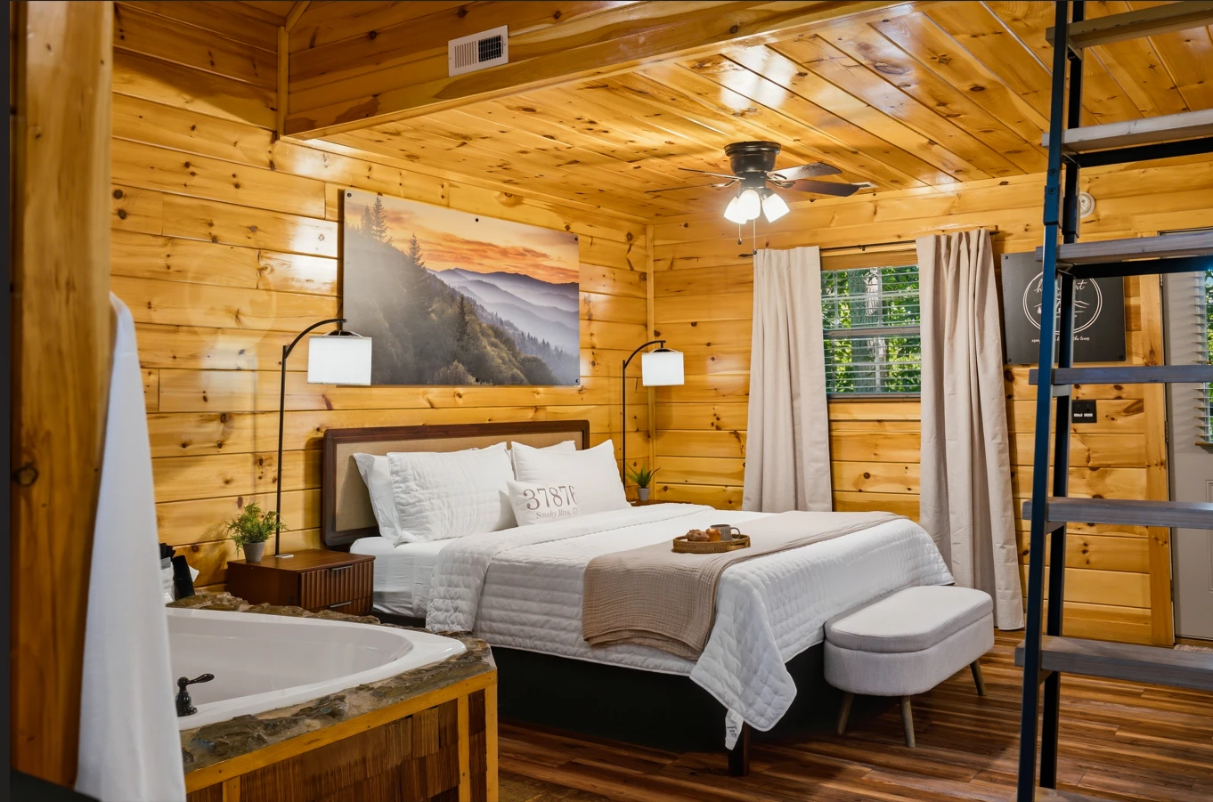Luxurious king bed with treetop views — a serene, romantic haven for two.