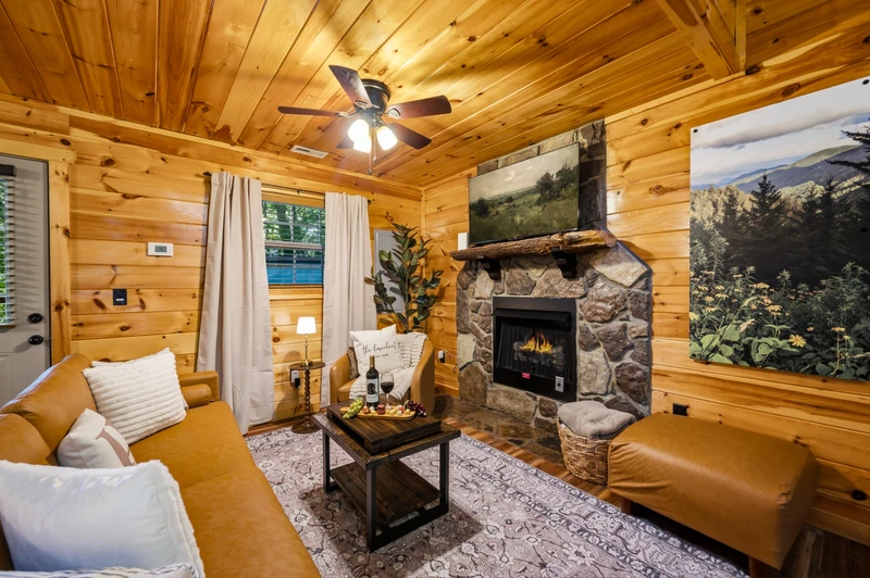 a warm living room designed for togetherness — streaming TV, game table, and a glowing fireplace.